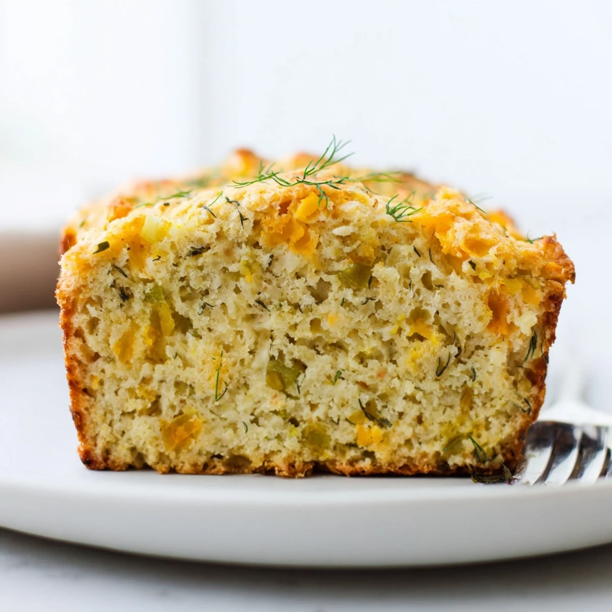 Warm, fluffy slices of Dill Pickle Sweet Tea Cheddar Biscuit Muffin Loaf ready to enjoy.  