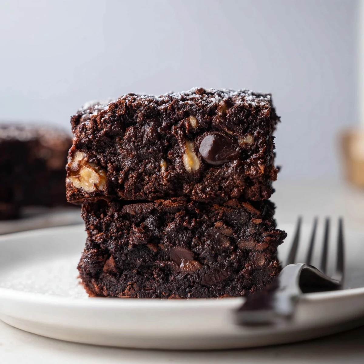 Fudgy Zero-Waste Brownies using leftover nut-milk pulp, topped with dark chocolate chips.  