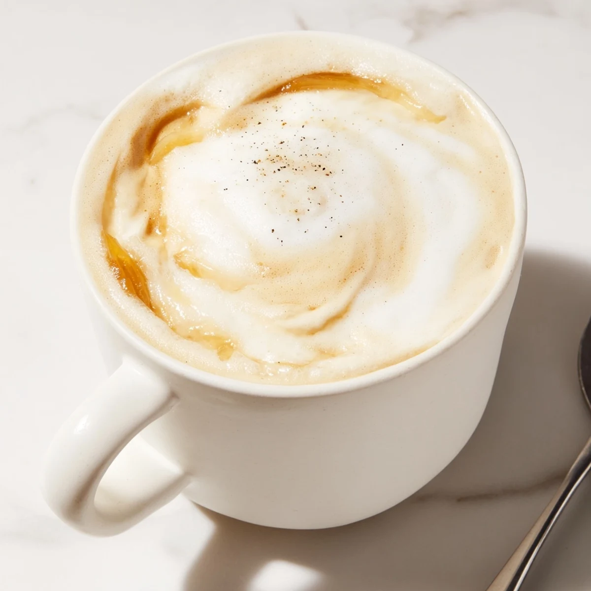 Bold and creamy Onion Latte topped with a sprinkle of black pepper for extra zest.