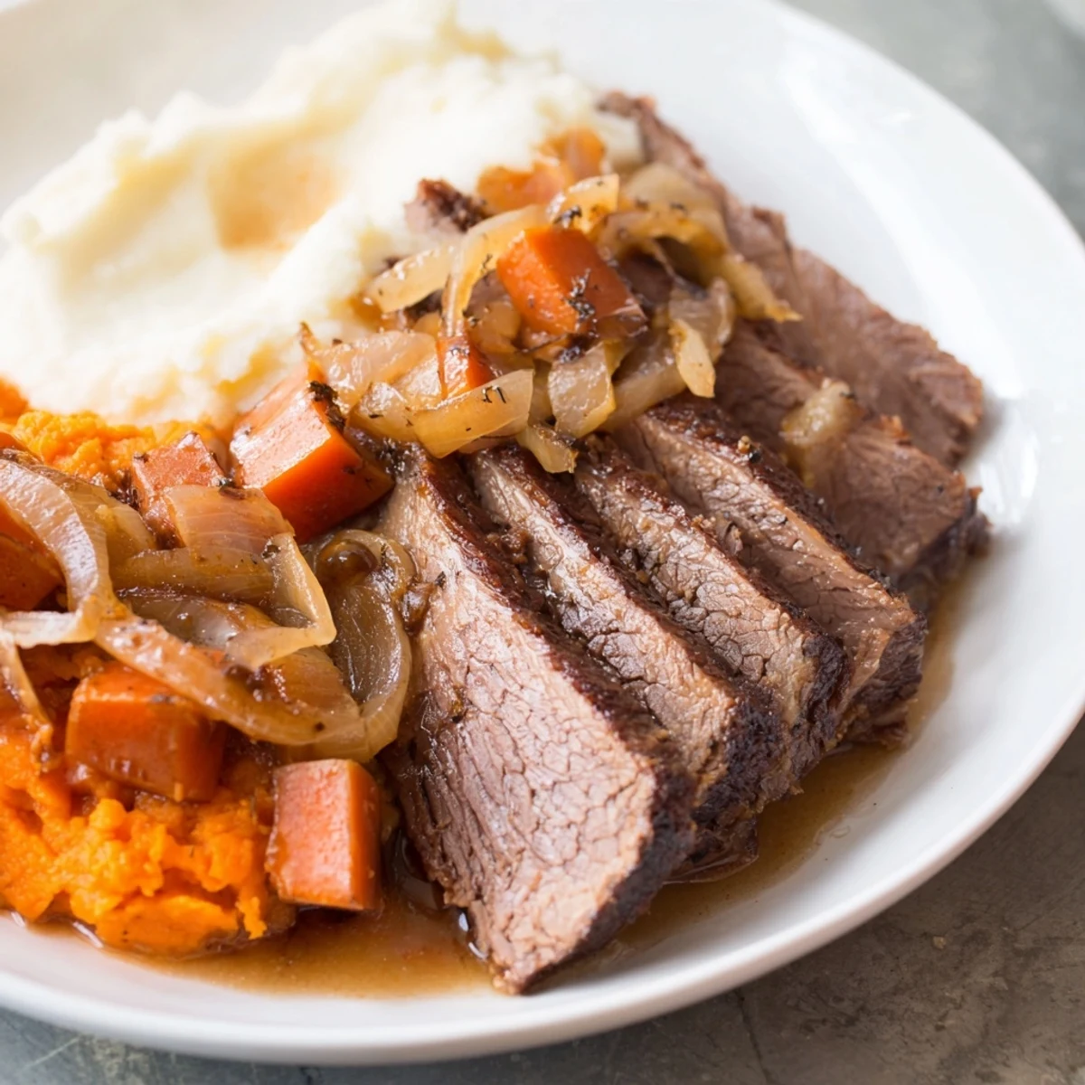 Tender Classic Brisket and Mashed Sweet Potatoes, served with savory gravy and beautiful fall colors.