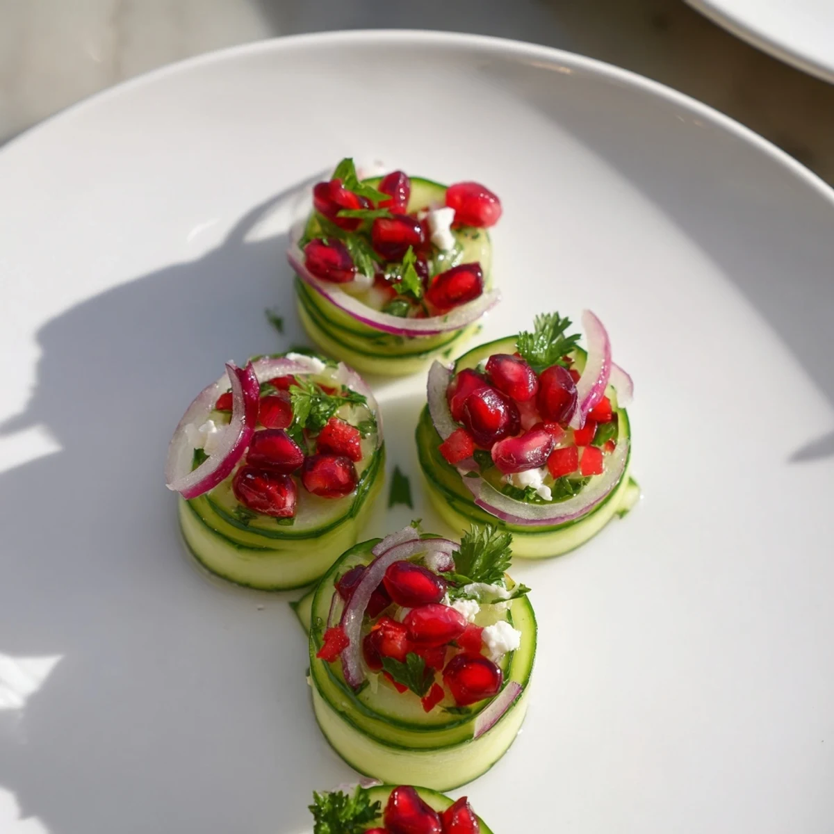 Healthy Cucumber Christmas Salad, a vibrant mix of cucumbers, pomegranate, and citrus dressing ready to serve.