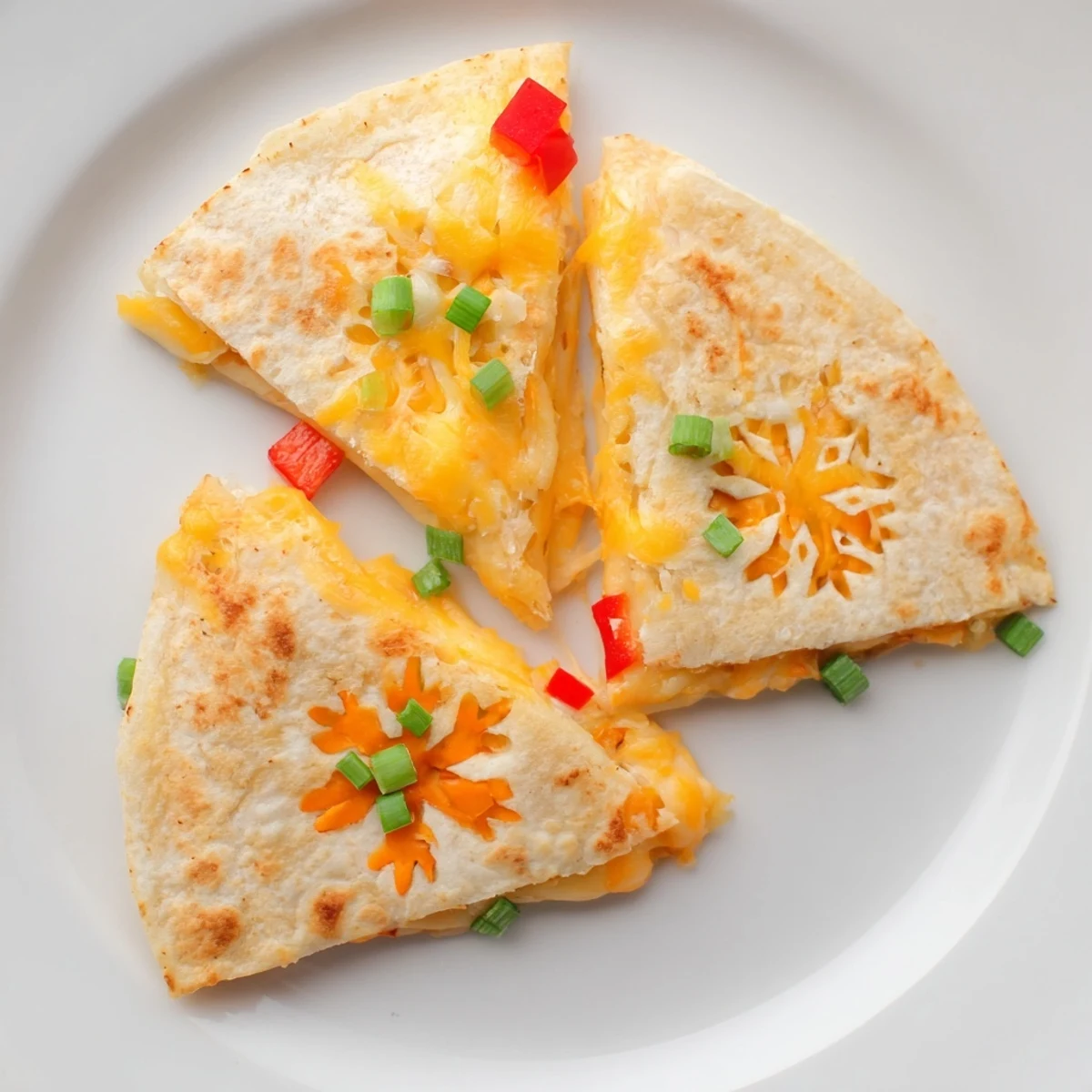 Express Snowflake Quesadillas, golden-brown and cheesy, ready for dipping into sour cream and salsa.