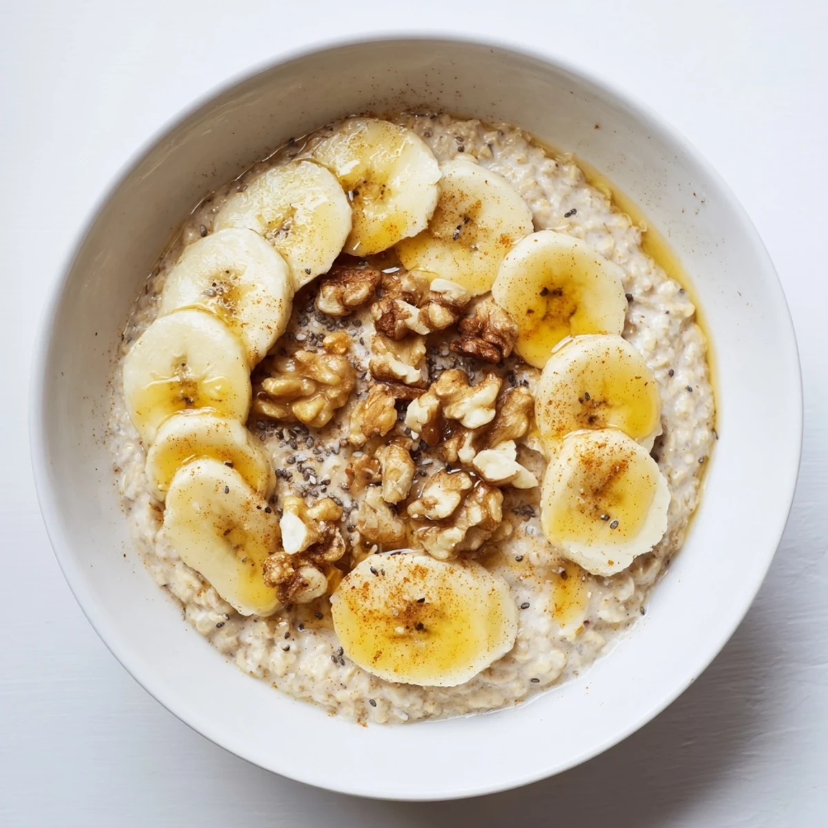 Steaming bowl of Microwave Banana Oats with sliced banana and a sprinkle of cinnamon, ready to eat.