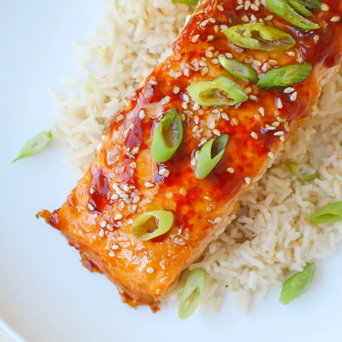 A close-up of perfectly broiled Sticky Orange Salmon, with caramelized edges and a tangy glaze, ready to eat.