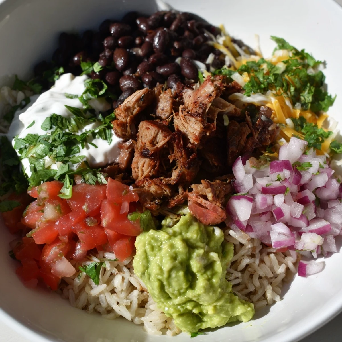This delicious Chipotle Burrito Bowl copycat features vibrant cilantro-lime rice and fresh, zesty salsa.