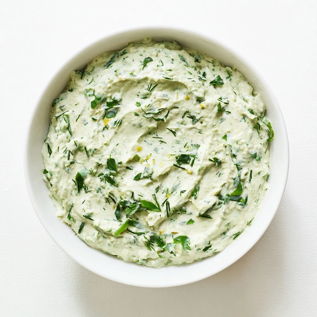 Creamy Green Goddess Salad Dip, perfectly blended with fresh herbs and served alongside colorful vegetables.