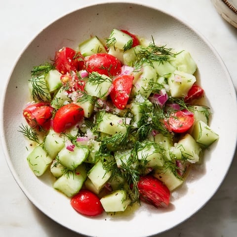 Simple Cucumber and Dill Chopped Salad, boasting vibrant green cucumber chunks and herbs, refreshingly prepared with a zesty lemon dressing.