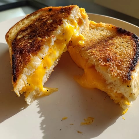 Golden, gooey Custard French Toast Grilled Cheese oozing melted cheese, a brunch time favorite.