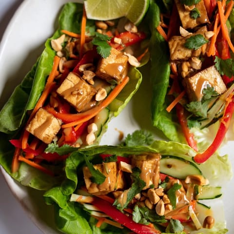 Imagine filling crisp lettuce cups with seasoned tofu for delicious Thai Peanut Tofu Lettuce Wraps.