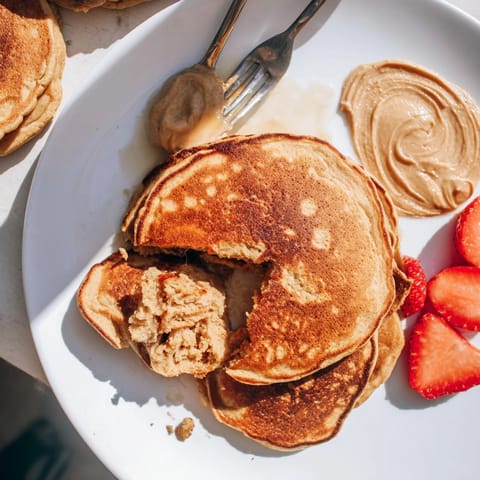 A vibrant stack of Cinnamon Sweet Potato Protein Pancakes, warm and subtly spiced breakfast.