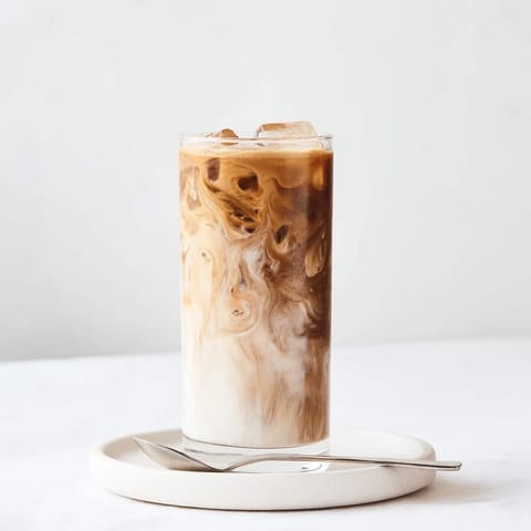 Rich and nutty Tahini Iced Coffee garnished with cocoa powder for extra flavor.  