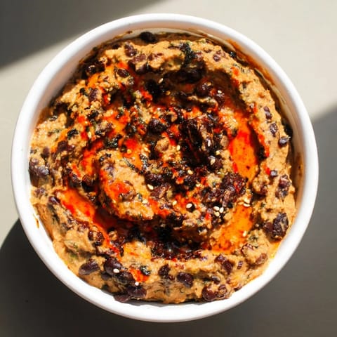 Easy-to-make, Mexican-inspired Spicy Black Bean Dip, perfectly blended and ready to serve.