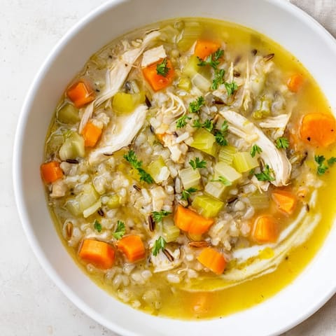 Close-up of Quick Chicken and Wild Rice Soup showing tender chicken and fluffy wild rice, savory and filling.