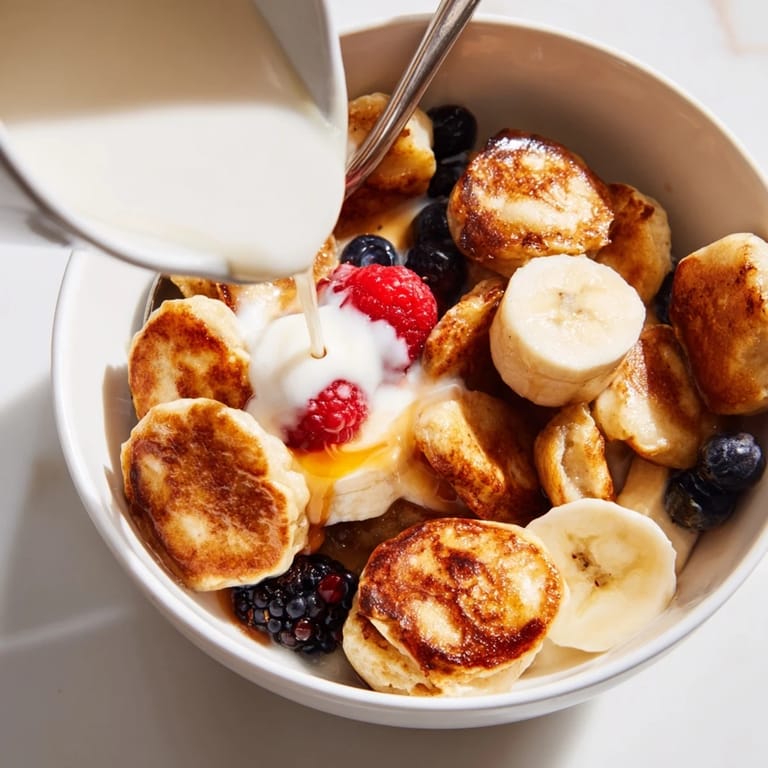 Bite-sized mini pancake cereal, golden brown and fluffy, perfect for brunch.  