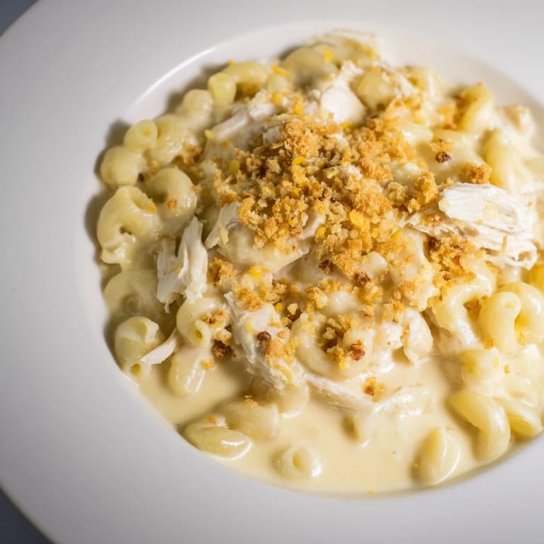 Golden, bubbly baked Struggle Meal Chicken Macaroni topped with breadcrumbs, smelling savory and delicious, ready to eat!