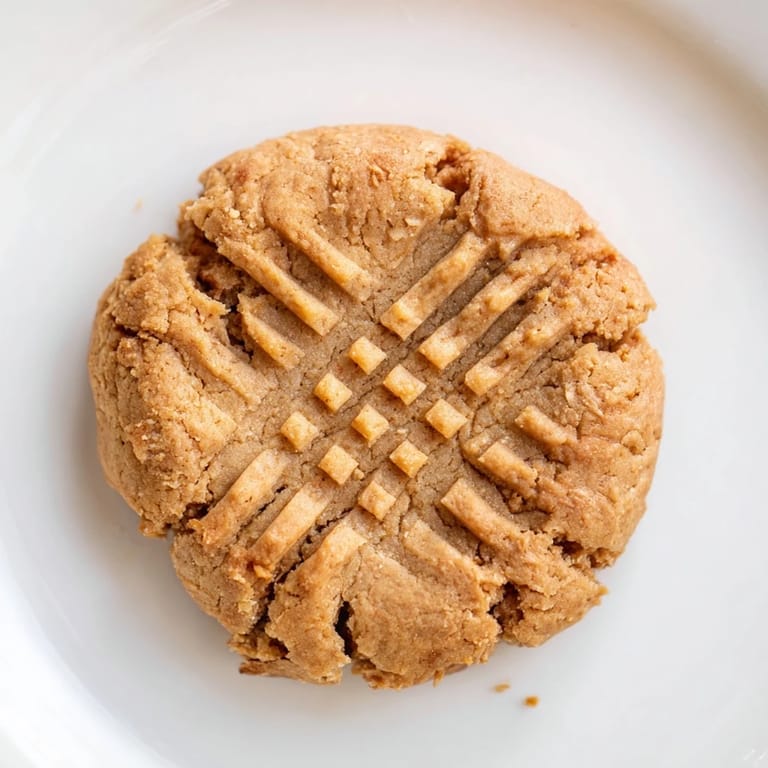 Crisscross-patterned flourless peanut butter cookies; a simple, gluten-free dessert option.